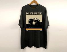 a t - shirt hanging on a wall with the words daft punk printed on it