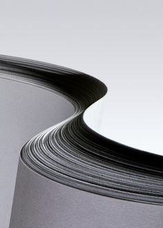 two stacks of black and white paper stacked on top of each other