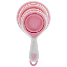 three pink and white measuring spoons stacked on top of each other