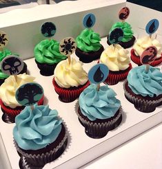 cupcakes with blue and green frosting in a box