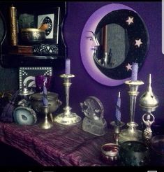 a table topped with candles next to a mirror and other items on top of it