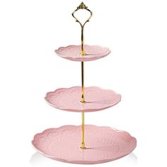 three tiered tray with gold handles and pink plates on it, each holding a heart shaped