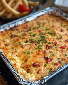 a cheesy casserole in a metal pan on top of a stove