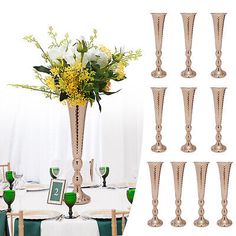 there are many vases with flowers in them on the table set up for a party