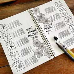 a spiral notebook with planner stickers and a pen