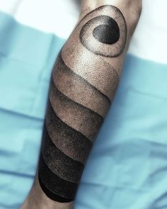 a man's arm with an abstract tattoo on it