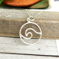 "Save 25% off your next purchase, sign up here: www.justjaynes.com/sign-up Wave Necklace. This ocean necklace features a rolling wave of sterling silver. Add a modern touch of beachy vibes to your look with this fun and curvy nautical jewelry. Silver wire is hand-formed into this playful shape, creating a gorgeous and fluid wave. The perfect charm for any beach lover! LISTING IS FOR: - One sterling silver charm necklace. --------------------------------------------------------------------- FEATU Minimalist Gift Ideas, Sterling Silver Charm Necklace, Wanderlust Jewelry, Ocean Necklace, Wave Necklace, Beachy Vibes, Nautical Jewelry, Beach Gifts, Minimalist Gifts