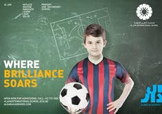 a young boy holding a soccer ball in front of a chalkboard with the words, where brilliante soars