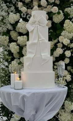 a white wedding cake sitting on top of a table