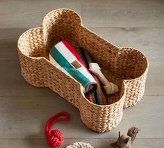 a basket filled with items sitting on top of a wooden floor next to a stuffed animal