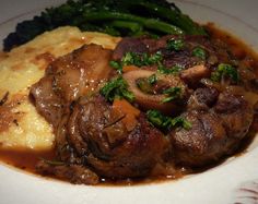 a plate with mashed potatoes, broccoli and meat in gravy