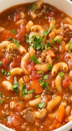 a white bowl filled with pasta and meat soup