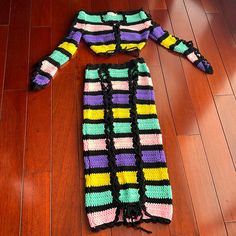 a crocheted sweater laying on top of a wooden floor