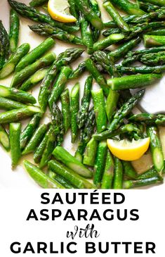 cooked asparagus with garlic butter and lemon on a white platter next to the recipe title