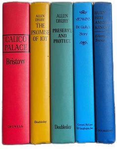 the seven books are lined up on each other in blue, red, yellow and green