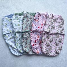 five baby swaddles laid out on the ground