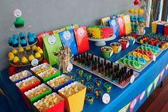 the table is full of colorful snacks and desserts