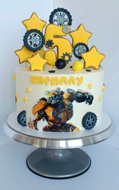 a birthday cake with an image of a robot and stars on the top is shown