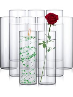 there are many vases with flowers in them and one has a red rose inside