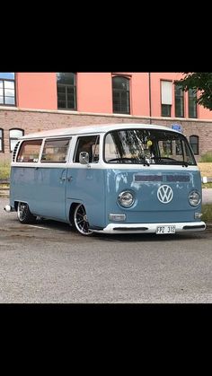 an old vw bus parked in front of a building