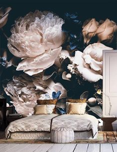 a large flowered wall mural in a bedroom with a bed and rug on the floor