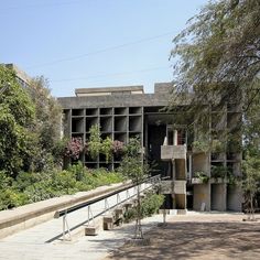 an old building with plants growing out of it