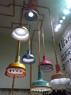 many different colored lights hanging from the ceiling