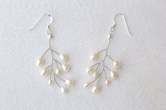 These freshwater pearl dangle earrings are the perfect finishing touch for an elegant bridal look.   I made these earrings to match my silver freshwater pearl pins: https://etsy.me/2IIrJnC The earrings are made using freshwater pearls and sterling silver ear wires. The earrings come in a branded box and will be sent via tracked shipping to ensure safe delivery.  If you have any questions or customisation requests please get in touch. Pearl Earrings Drop, Pearl Pins, Drop Earrings Pearl, Jewellery Pearl, Flower Girl Bracelets, Pearl Earrings Wedding, Pearl Jewelry Wedding, Pearl Pin, Freshwater Pearl Earrings