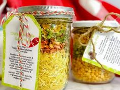 two jars filled with food sitting on top of a table