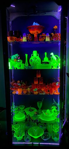 an illuminated display case filled with lots of different items