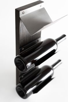 a wine rack with three bottles and a bottle opener on the top of each one