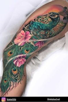 a woman's leg with a peacock and flowers on it