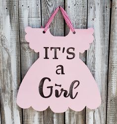 it's a girl sign hanging on a wooden fence