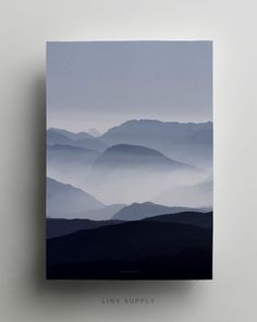 an image of a mountain range with fog in the valley and sky above it that reads link supply