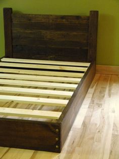 a bed frame made out of wood with no headboard or foot board on it