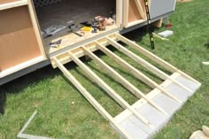 the back end of a trailer is being built with plywood and other woodworking tools