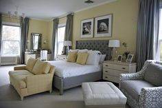 a bedroom with yellow walls and white furniture