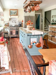 a kitchen filled with lots of counter space and wooden flooring next to an oven