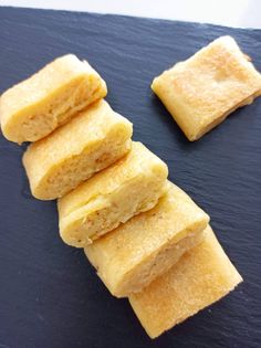 five pieces of food sitting on top of a blue cutting board