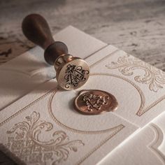 a wax stamp with the word love on it sitting on top of an ornate envelope