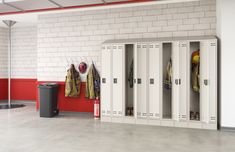 lockers with fireman's gear are lined up against the wall in an empty room