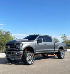 a large silver truck parked in a parking lot