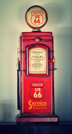 an old fashioned route 66 gas pump sitting on top of a shelf next to a wall