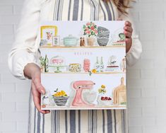 a woman holding up a card with the words recipes on it