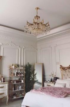 a bedroom with a chandelier hanging from the ceiling