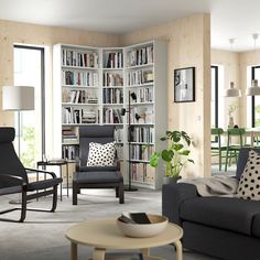 a living room filled with furniture and bookshelves