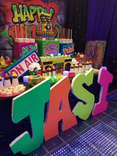 an assortment of cakes and cupcakes on display at a birthday party