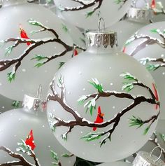 white christmas ornaments with red birds on them