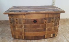 a wooden box sitting on top of a tiled floor