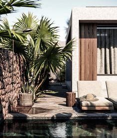 an outdoor lounge chair sitting next to a pool